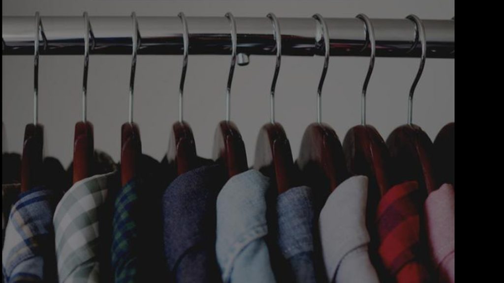 A row of premium cotton shirts on hangers, showcasing Jack & Jones Canada’s sustainable fashion collection and Better Cotton Initiative